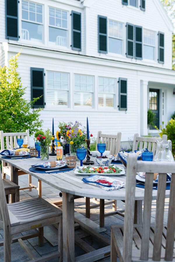  Furniture from Kingsley Bate makes a cozy spot to dine alfresco. Shutters from New England Shutter. 