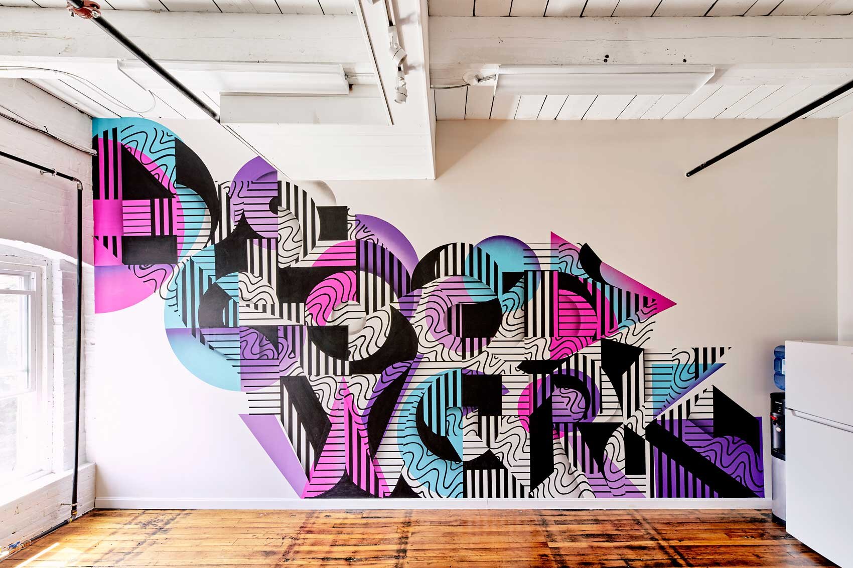 Portland artist Ryan Adams gives his treatment to Dirigo Collective’s guiding principle: Do Good Work. The directive is visible from almost any spot in their new Yarmouth headquarters.