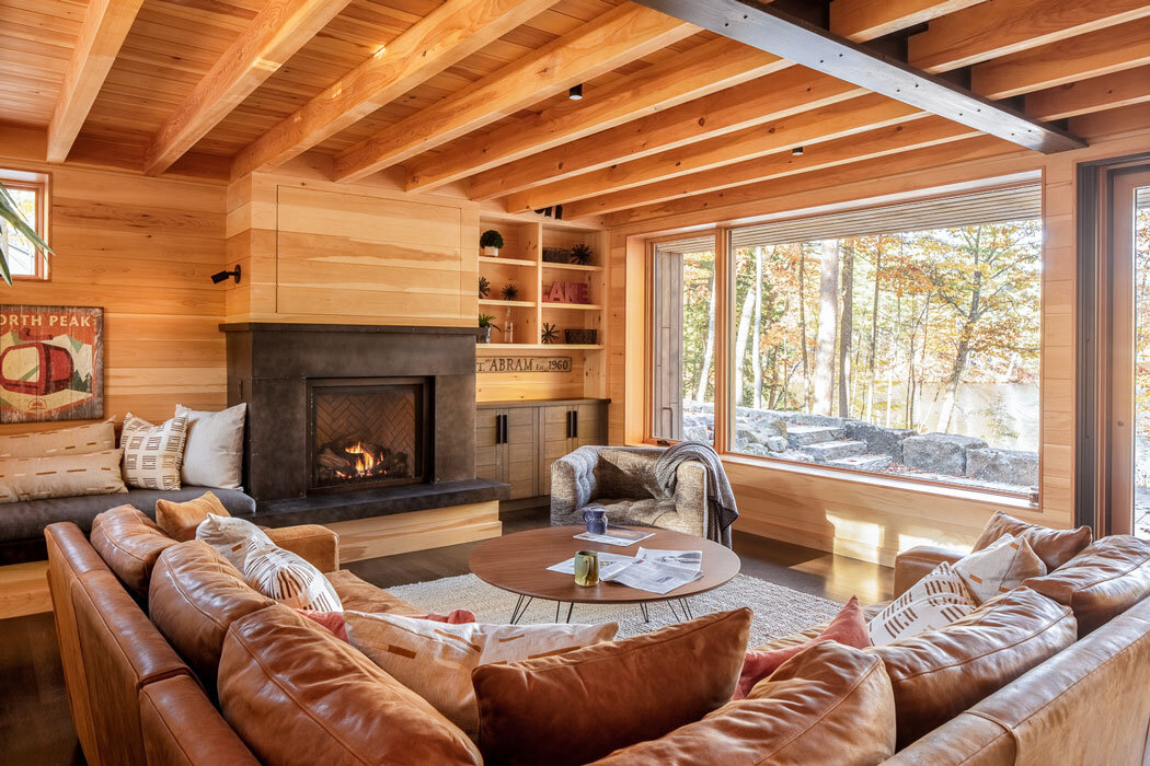 Ground-floor great room. The panel above the Western Maine Steel fireplace slides away to reveal a television.