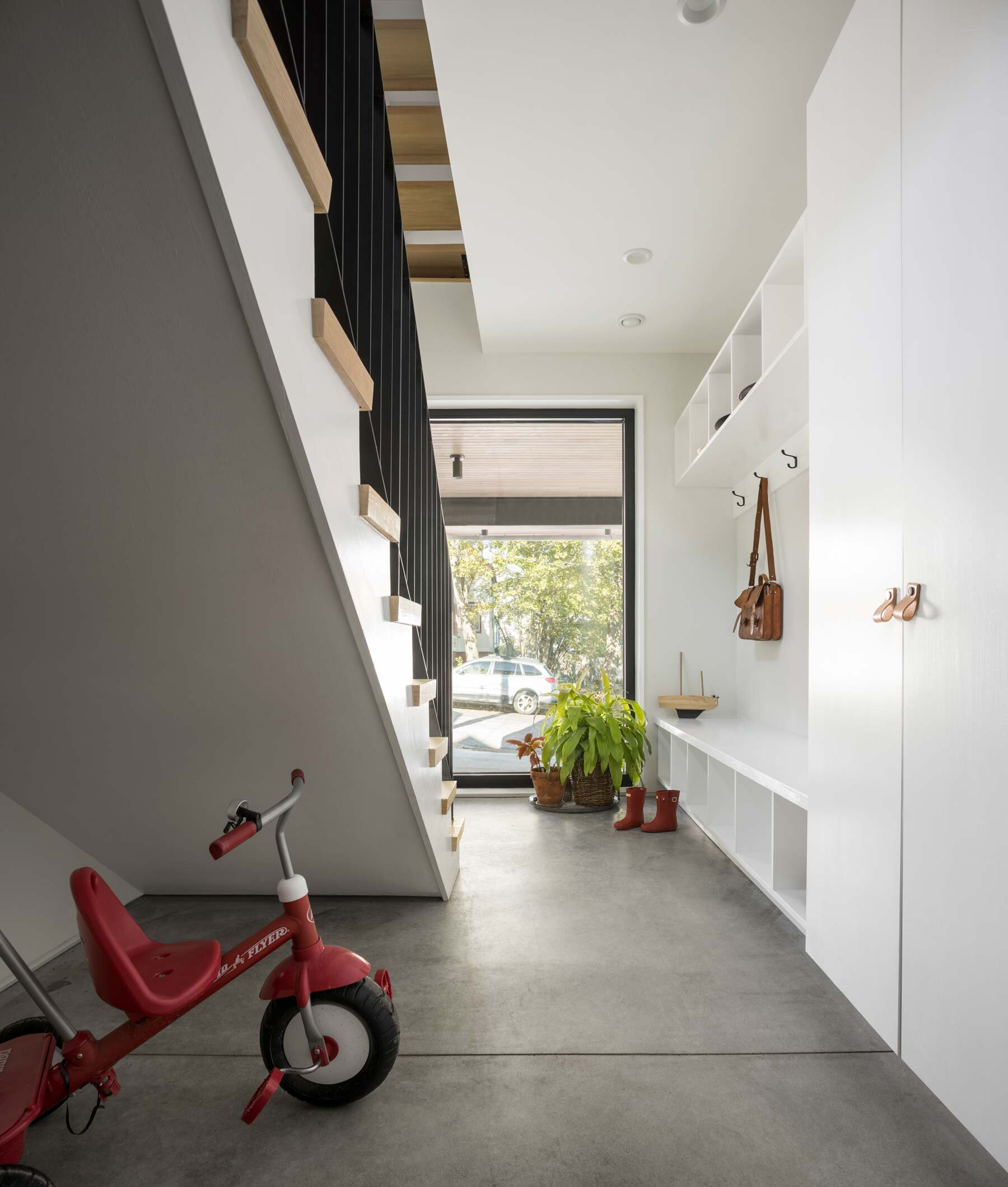  The mudroom’s concrete floor and plentiful cubbies make it easy to stay neat and organized, no matter the weather. 