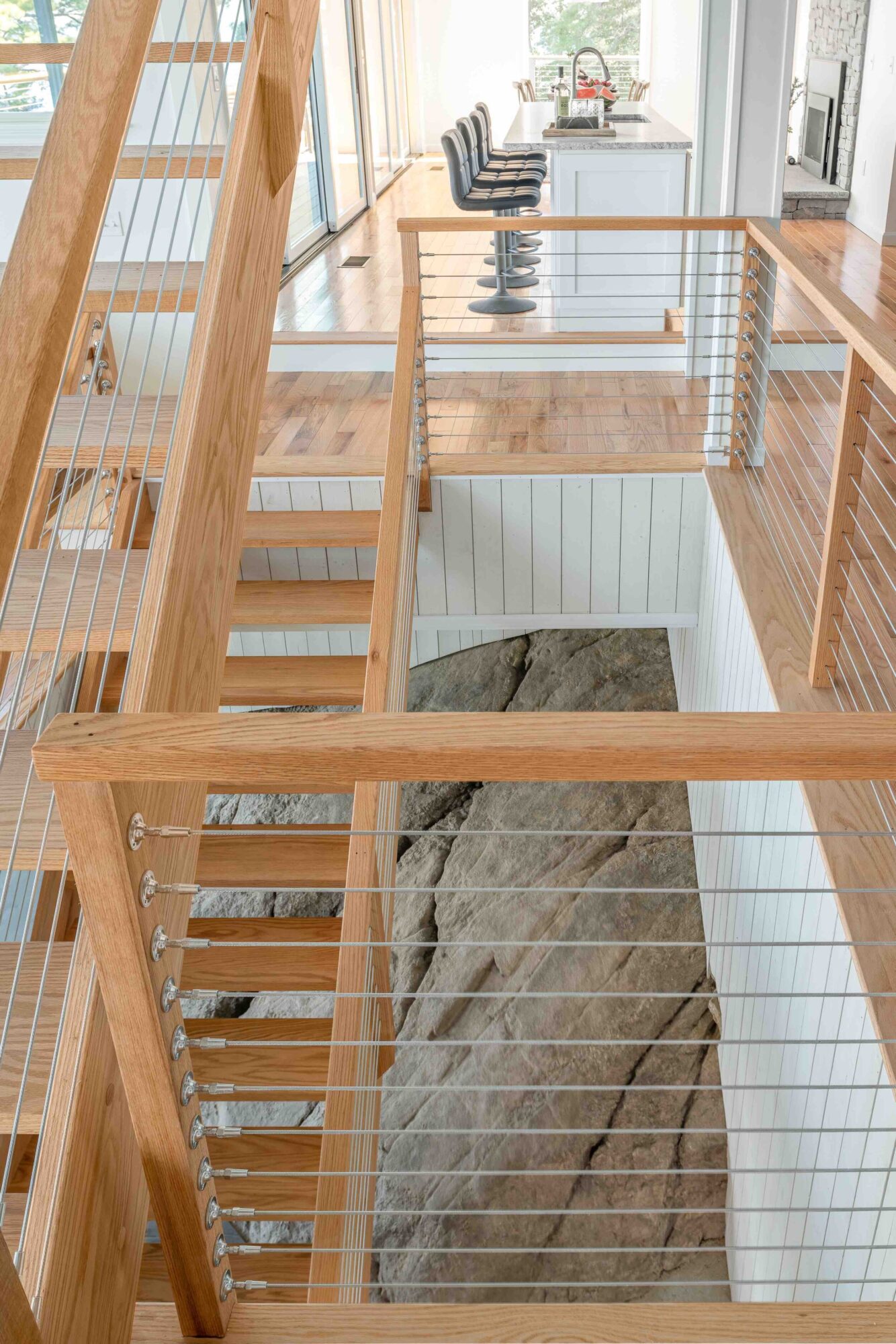  The striking staircase— clad in hardwood from Fat Andy’s Hardwoods— was designed by Ross and proudly commands center stage at the heart of the home. 