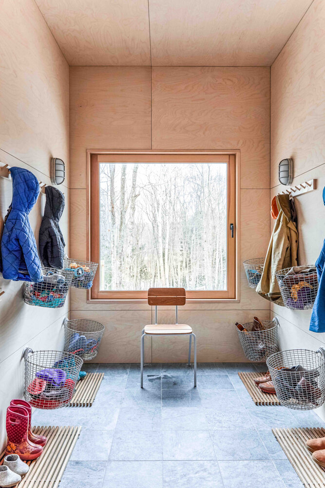  Mats by Skagerak Design and baskets from Korbo keep order in the mudroom of this family of five. 