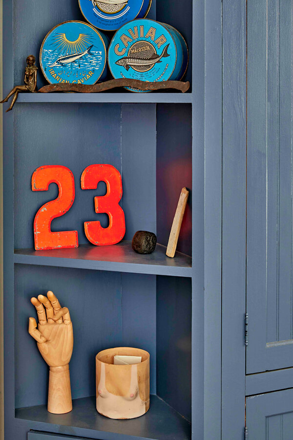  The house numbers from Will and Tessa’s previous home accompany other collected items from friends and travels. 