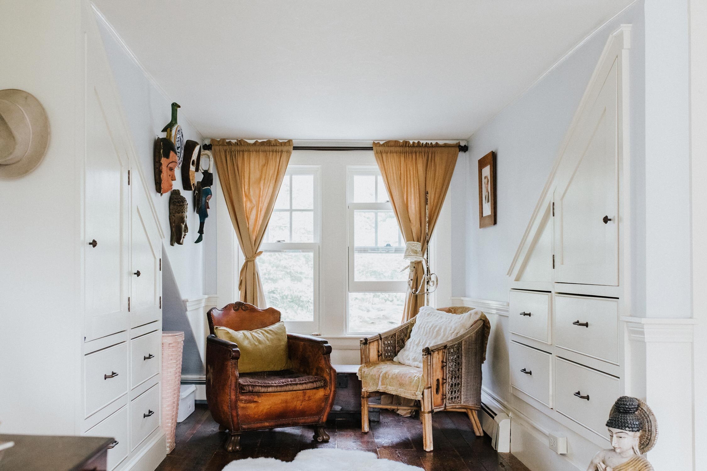  His and hers reading chairs in the owner’s bedroom suite. On either side, white built-in cabinets and drawers provide additional storage without taking up unnecessary space. 