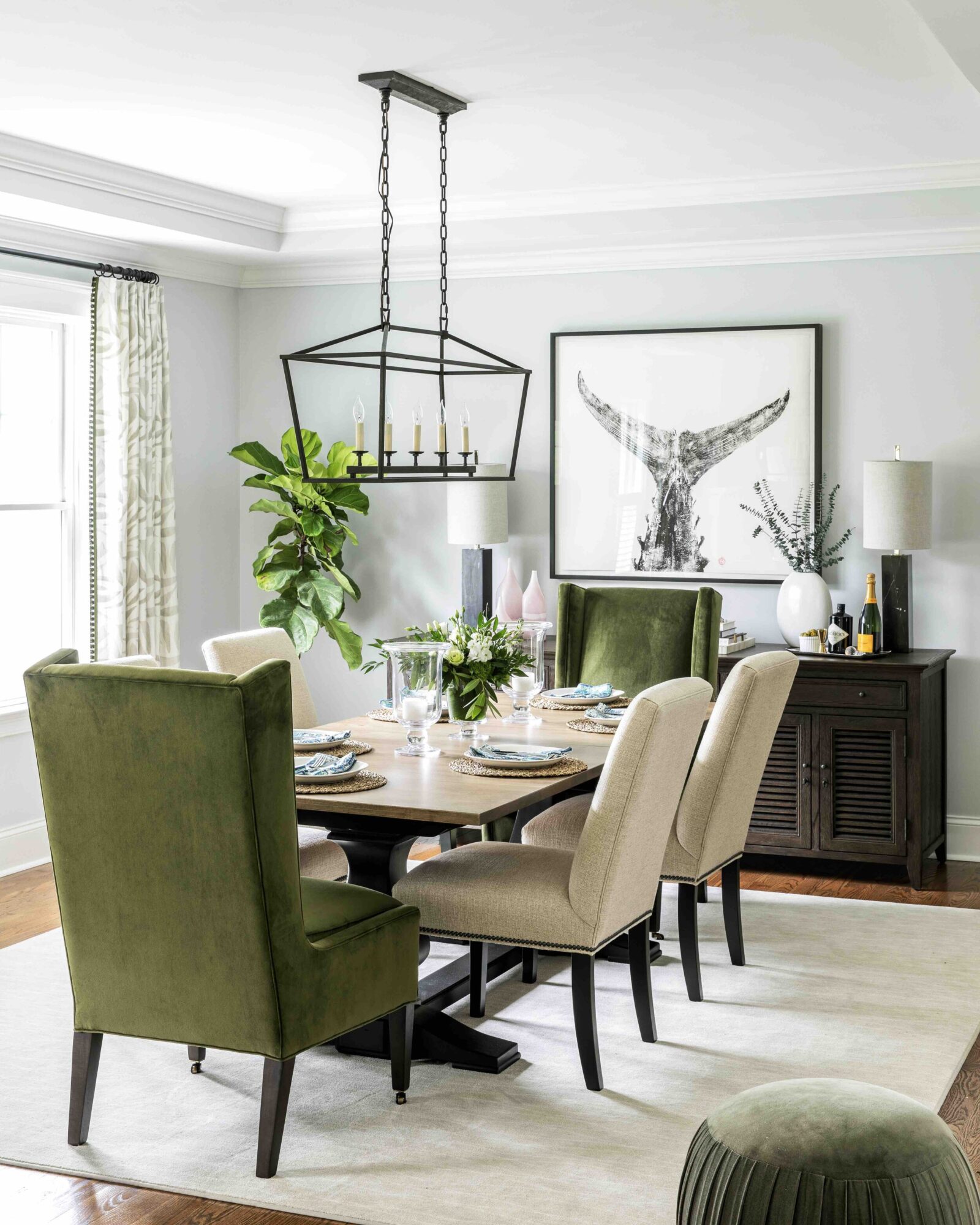 Luscious green furnishings and botanical elements bring the outside in. Fish tail artwork by Peter VanDingstee. Design by Laura Pierce.