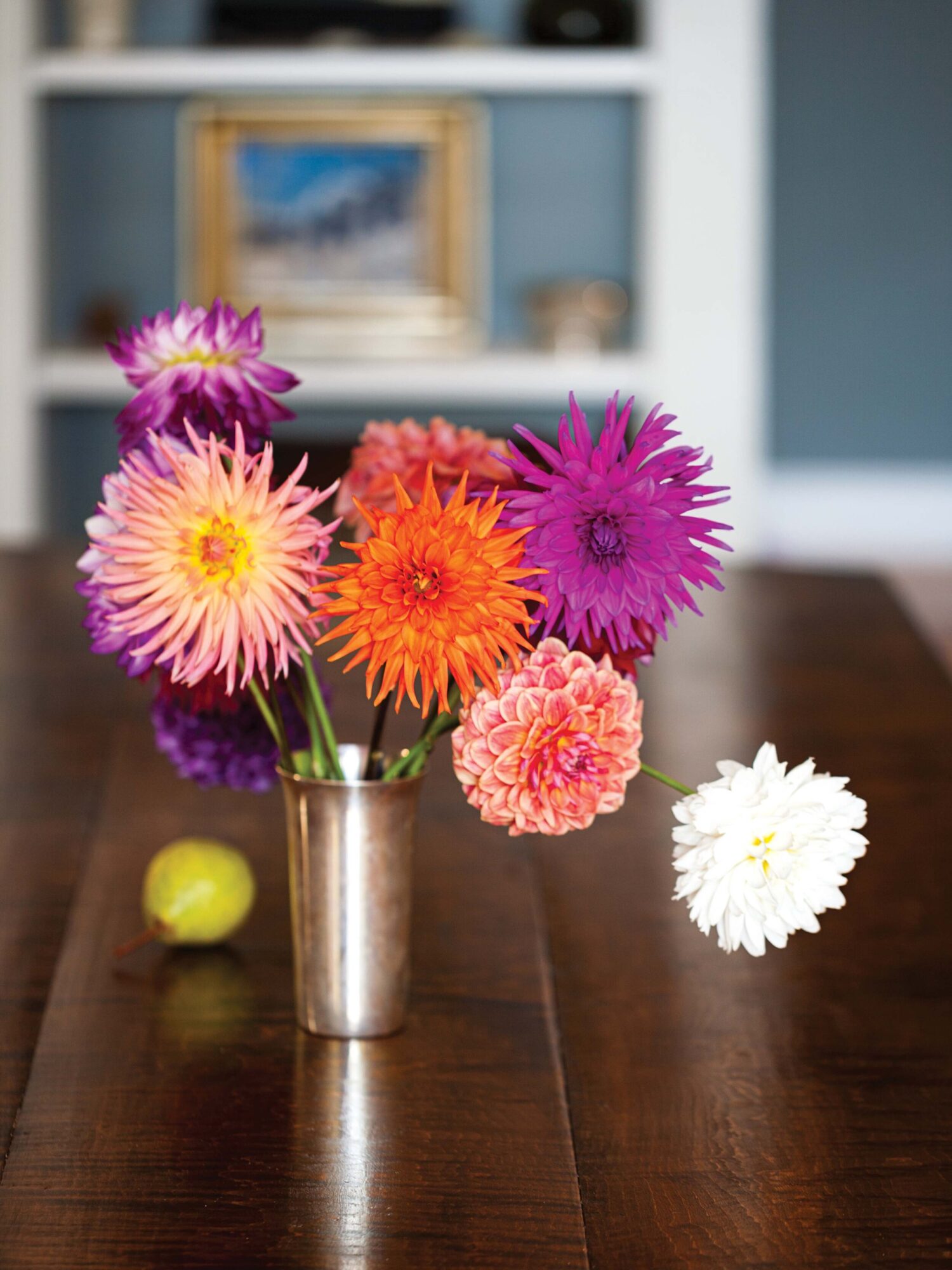  On the dining table, dahlias from Endless Summer Farm in Camden fill a classic mint julep cup. 
